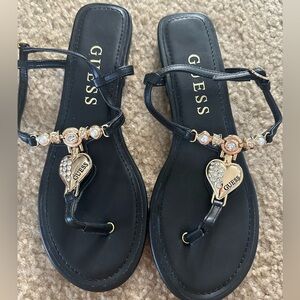 GUESS Black T-Strap Sandals with Gold Crystal Heart Charm